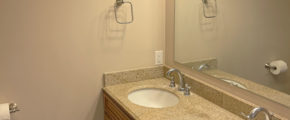 a bathroom with a double sink and a large mirror