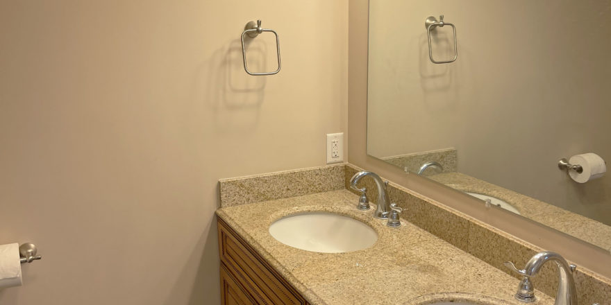 a bathroom with a double sink and a large mirror