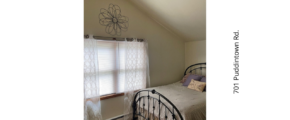 a bedroom with a ceiling fan and a bed