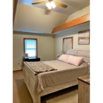 a bedroom with a ceiling fan and a bed
