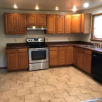 a kitchen with wooden cabinets and stainless steel appliances