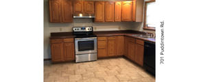 a kitchen with wooden cabinets and stainless steel appliances