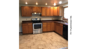 a kitchen with wooden cabinets and stainless steel appliances