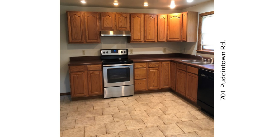 a kitchen with wooden cabinets and stainless steel appliances