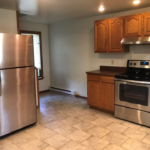 a kitchen with stainless steel appliances and wooden cabinets