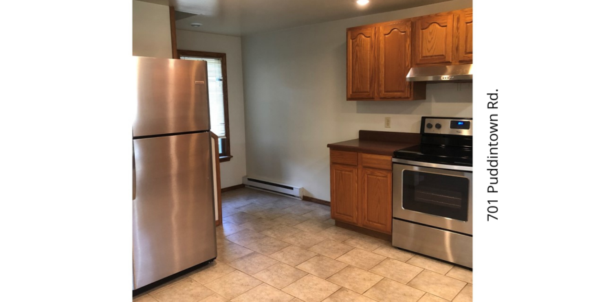 a kitchen with stainless steel appliances and wooden cabinets