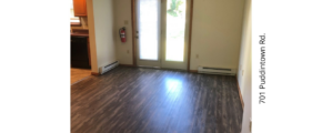 an empty living room with wood floors and sliding glass doors