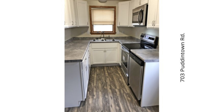 a kitchen with white cabinets and stainless steel appliances