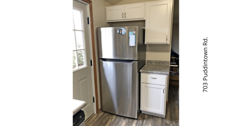 a stainless steel refrigerator freezer sitting in a kitchen