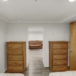 two beds in a room with white walls