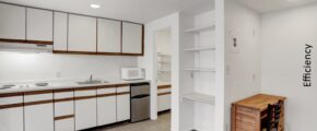 an empty kitchen with white cabinets and wood flooring