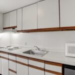 a kitchen with white cabinets and a microwave