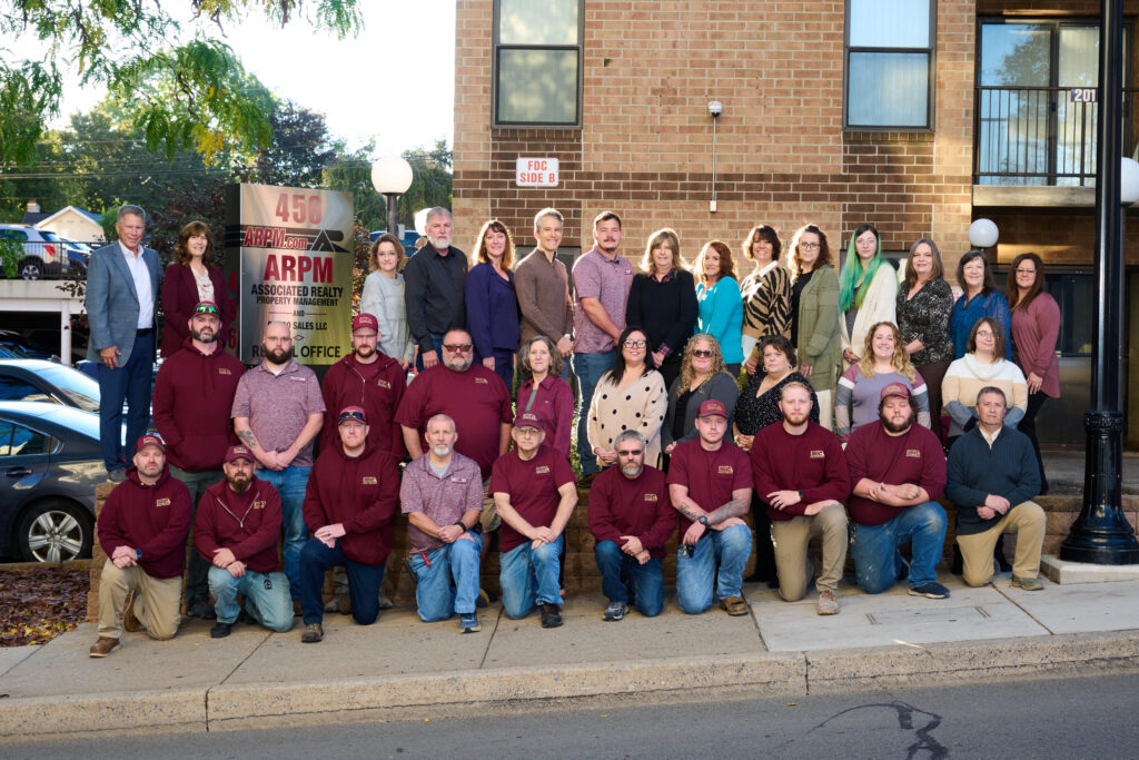 a group of people standing on the side of a road