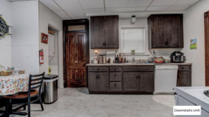 downstairs unit kitchen with counter top space and dark wooden cabinets