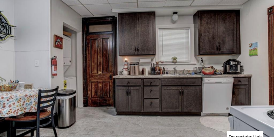 downstairs unit kitchen with counter top space and dark wooden cabinets