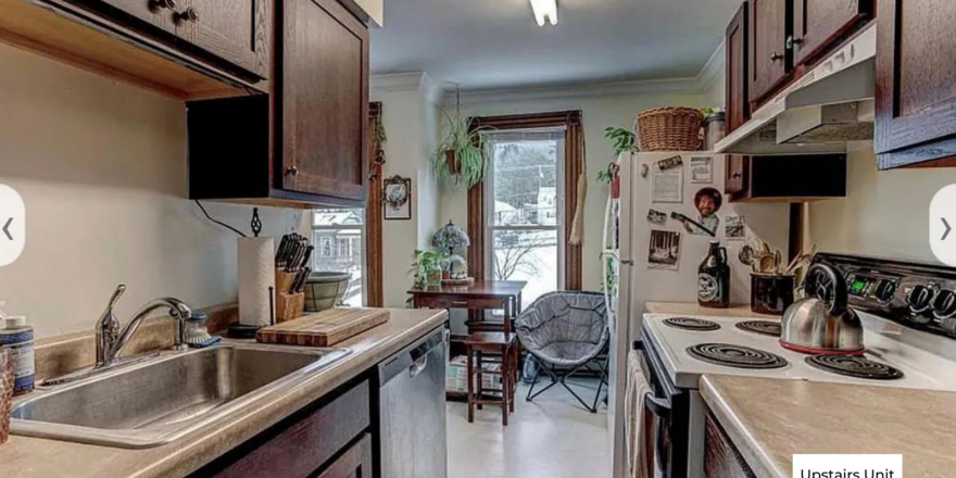 upstairs unit kitchen with a sink, stove and refrigerator