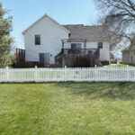 a white picket fence in backyard