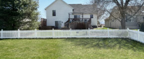 a white picket fence in backyard