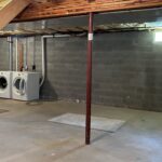 an unfinished basement with washer and dryer