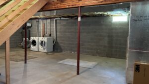 an unfinished basement with washer and dryer