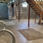 an unfinished basement with washer and dryer