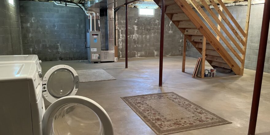 an unfinished basement with washer and dryer