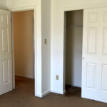 an empty bedroom with a spacious closet