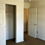 an empty bedroom with a spacious closet
