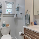 downstairs bathroom a white toilet sitting next to a bathroom sink