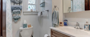 downstairs bathroom a white toilet sitting next to a bathroom sink