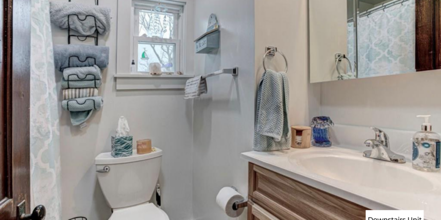 downstairs bathroom a white toilet sitting next to a bathroom sink