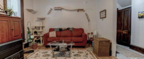 downstairs unit living room with white walls and wooden floors