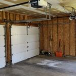 a garage with two overhead lights and a basketball hoop