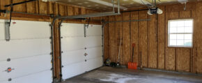 a garage with two overhead lights and a basketball hoop