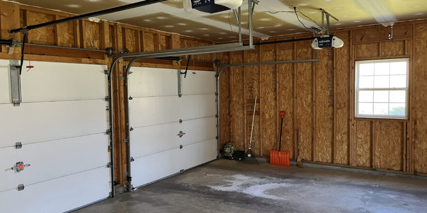 a garage with two overhead lights and a basketball hoop