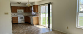 View of kitchen with a stove, microwave, dishwasher, counter, and sliding glass door to backyard