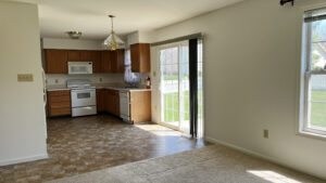 View of kitchen with a stove, microwave, dishwasher, counter, and sliding glass door to backyard