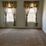 Master bedroom with two windows and curtains