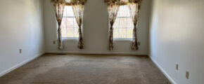 Master bedroom with two windows and curtains