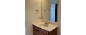 a bathroom with a sink, mirror and lights