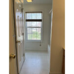 a hallway leading to bathroom window