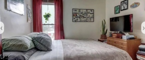 upstairs unit 1st bedroom with a neatly made bed and white walls