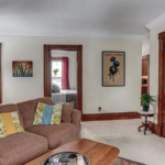 upstairs unit living room with white walls and light carpeting