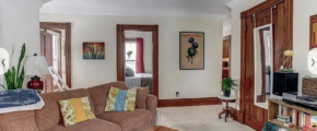 upstairs unit living room with white walls and light carpeting