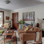 a living room filled with furniture and lots of windows