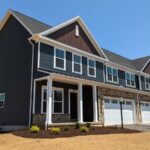 a row of houses with a two-car garage on each side
