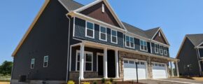 a row of houses with a two-car garage on each side