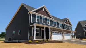 a row of houses with a two-car garage on each side