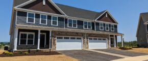 a row of houses with a two-car garage on each side