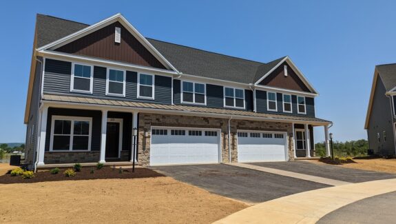 a row of houses with a two-car garage on each side